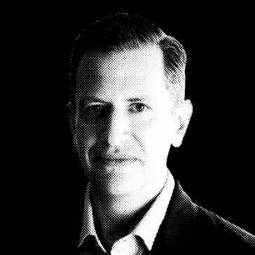 Black-and-white halftone portrait of a man in a suit jacket and collared shirt, facing the camera against a black background.